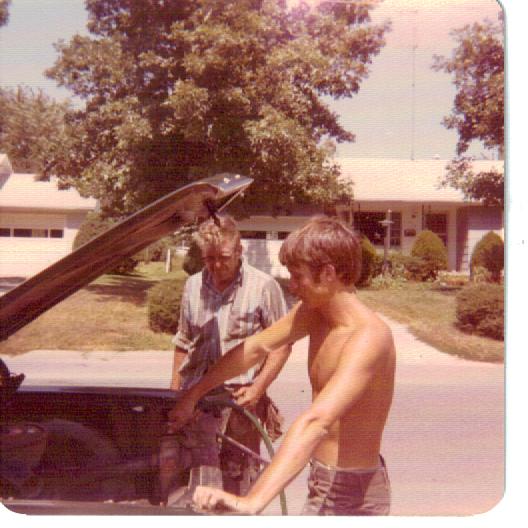 Dad looks on as I fill the radiator of my old 1968 Ford Galaxie